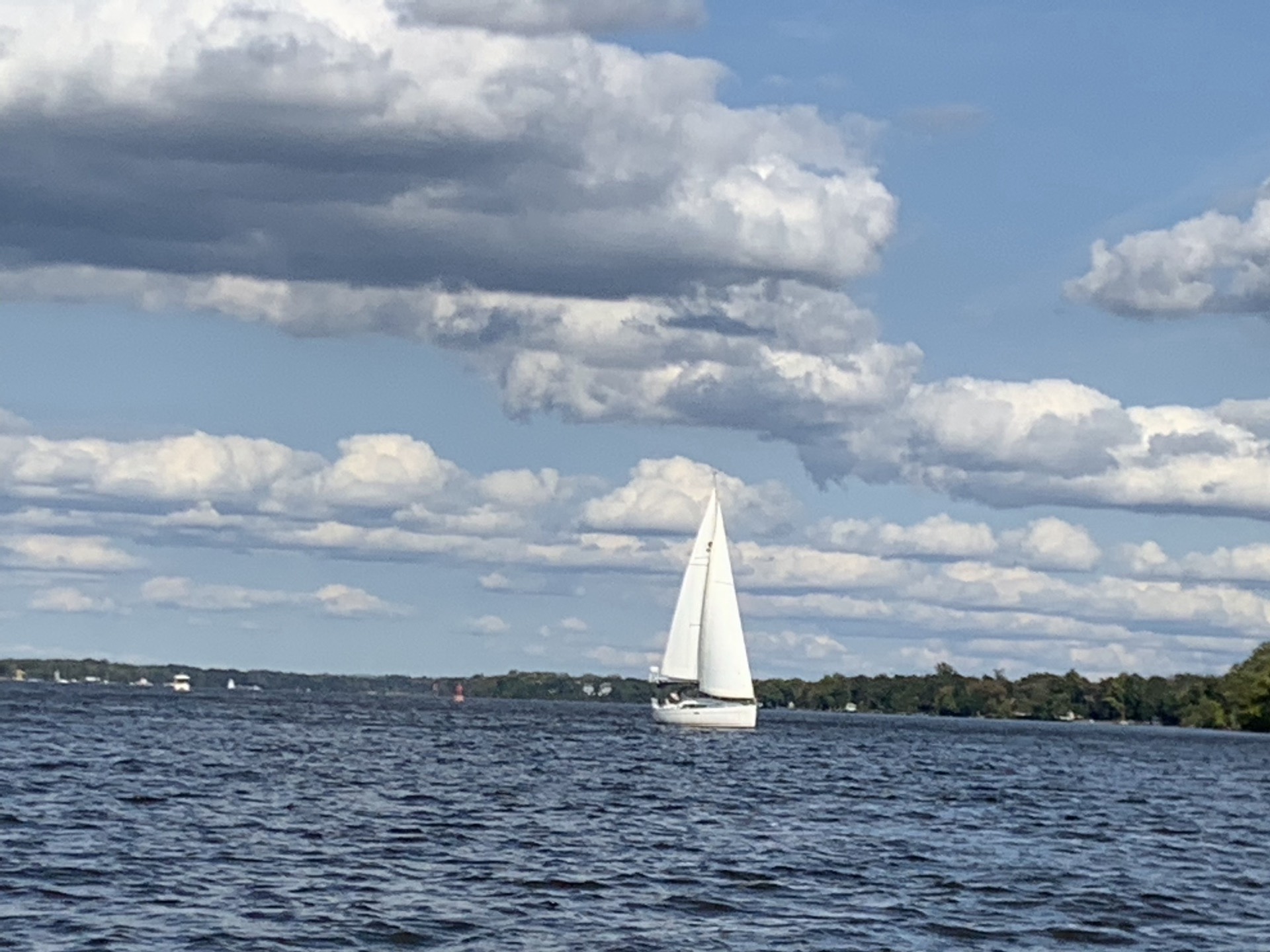 A sailboat under full sail on the Delaware River off the Pennsylvania Yacht Club